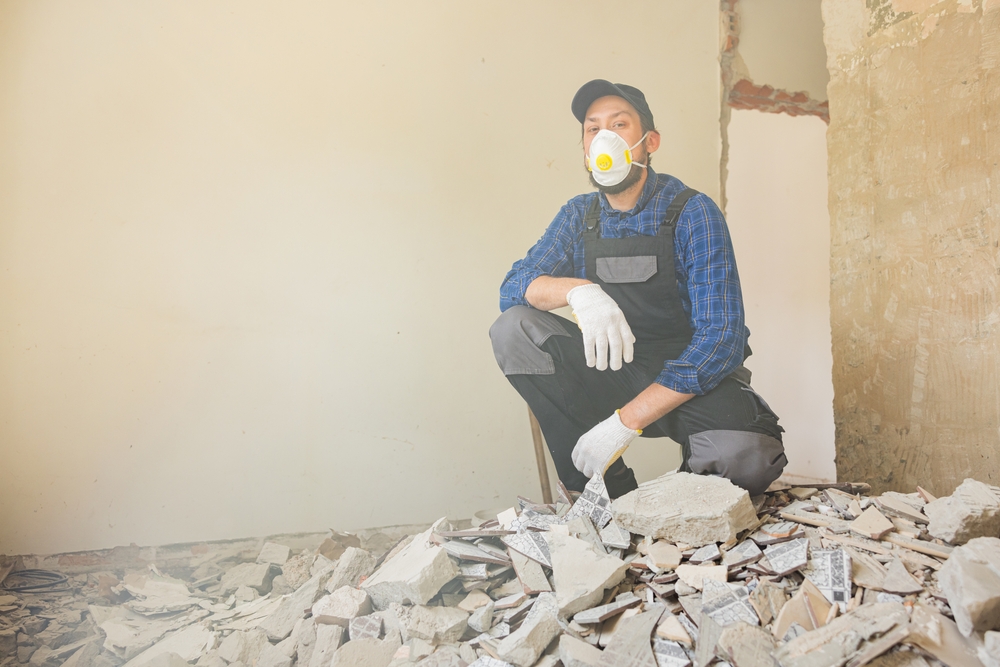 A,Men,Cleans,Up,After,Renovation,,Construction,Of,A,House.