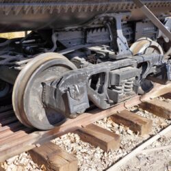 Old,Style,Railcar,Truck,Under,A,Riveted,Tank,Car