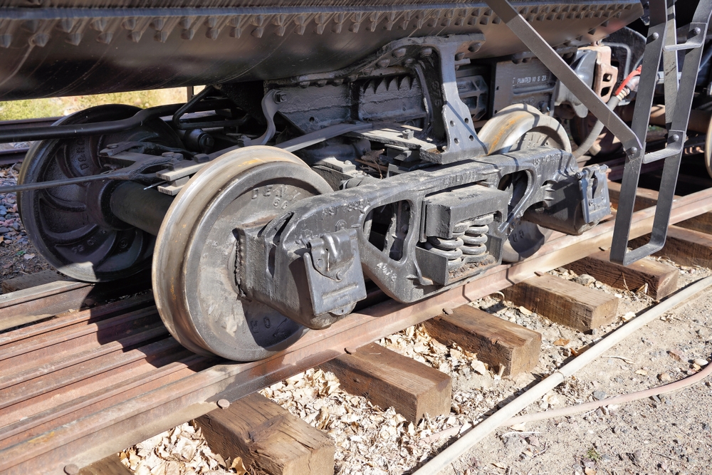 Old,Style,Railcar,Truck,Under,A,Riveted,Tank,Car