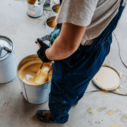 Worker,Mixing,Yellow,Epoxy,Resin,With,The,Mixer,In,A