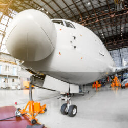 Airliner,Aircraft,In,A,Hangar,With,On,Jack,Stands