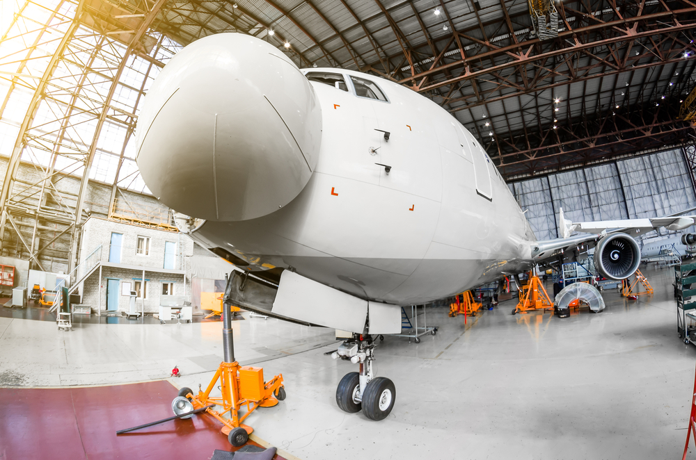 Airliner,Aircraft,In,A,Hangar,With,On,Jack,Stands