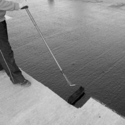 Waterproofing,Coating.,Worker,Applies,Bitumen,Mastic,On,The,Foundation.,Roofer