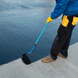 Waterproofing,Coating.,Worker,Applies,Bitumen,Mastic,On,The,Foundation.,Roofer